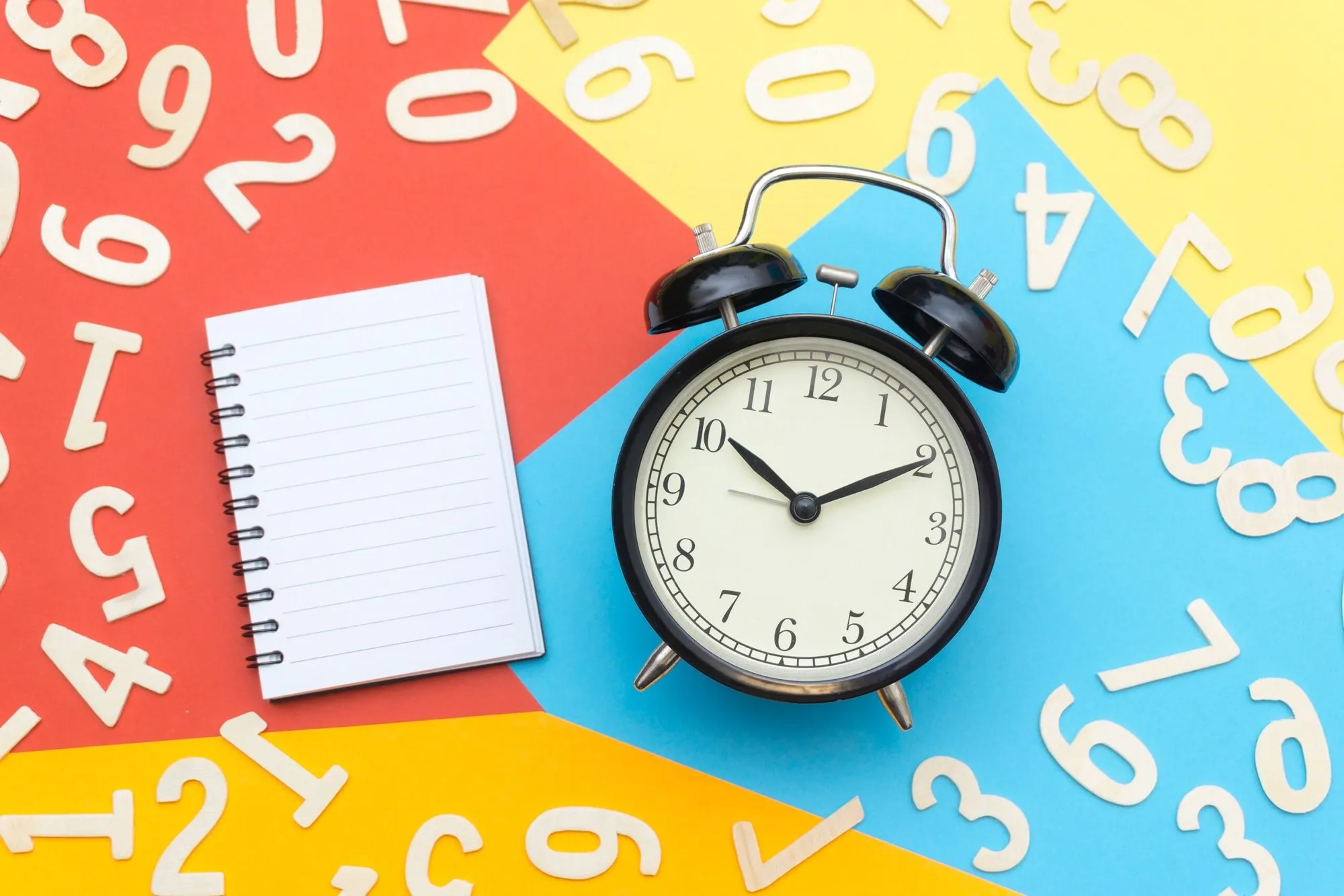 Alarm clock on a colorful background, representing our 7-day availability